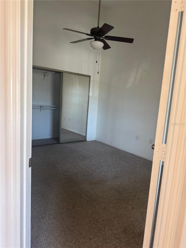 445 Fountainhead Cir Unit 264, Kissimmee, FL 34741 - unfurnished bedroom with a ceiling fan, a closet, and carpet floors