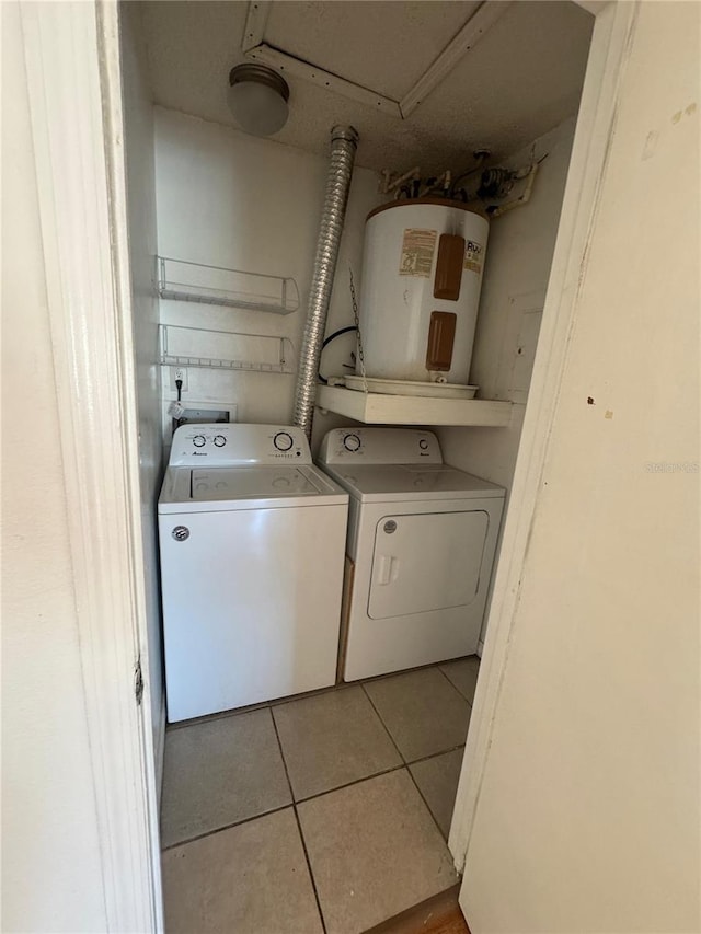445 Fountainhead Cir Unit 264, Kissimmee, FL 34741 - laundry room with laundry area, separate washer and dryer, water heater, and tile patterned floors