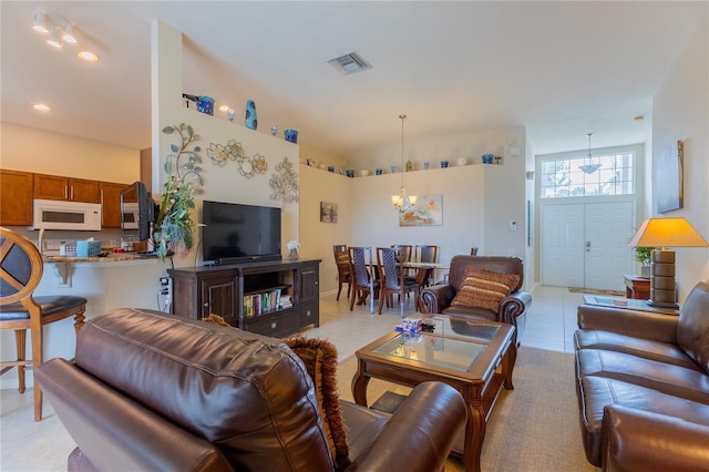 8204 Fan Palm Way, Kissimmee, FL 34747 - living room with a chandelier, light tile patterned floors, and recessed lighting