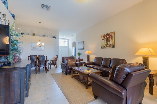 8204 Fan Palm Way, Kissimmee, FL 34747 - living area featuring a chandelier, arched walkways, and light tile patterned floors