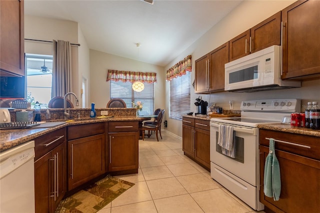 8204 Fan Palm Way, Kissimmee, FL 34747 - kitchen featuring white appliances, lofted ceiling, a sink, and light tile patterned floors