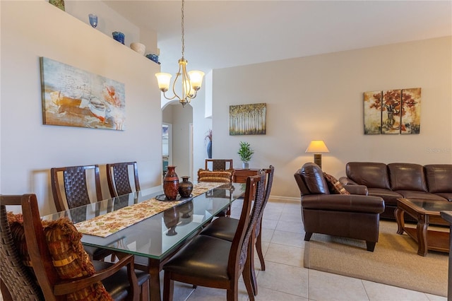 8204 Fan Palm Way, Kissimmee, FL 34747 - dining space with arched walkways, light tile patterned floors, and a chandelier