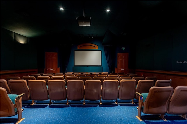 8204 Fan Palm Way, Kissimmee, FL 34747 - cinema room featuring wainscoting, lofted ceiling, and a decorative wall
