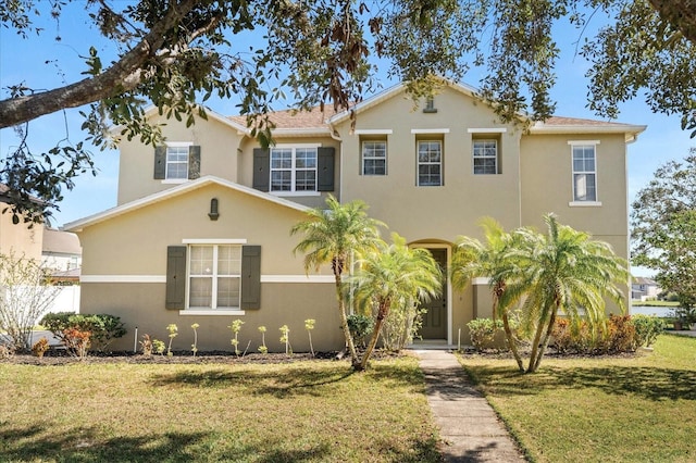 view of front of house featuring a front yard and stucco siding