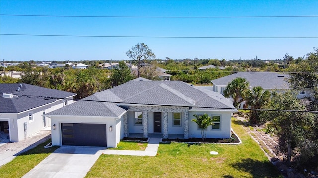 view of front of home featuring a front yard, concrete driveway, an attached garage, and a shingled roof