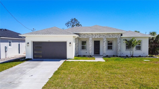 view of front facade with a front yard, driveway, stucco siding, a shingled roof, and a garage