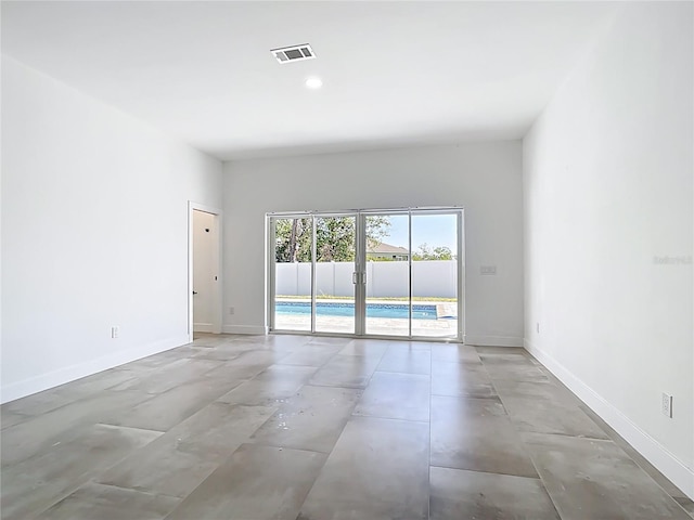 unfurnished room featuring visible vents, baseboards, and french doors