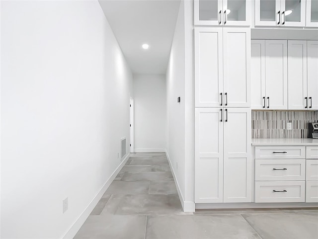 hallway featuring visible vents, recessed lighting, and baseboards