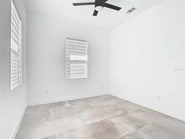 empty room featuring visible vents, baseboards, and ceiling fan