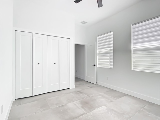 unfurnished bedroom with a closet, visible vents, a ceiling fan, and baseboards