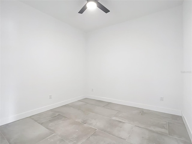 empty room featuring baseboards and ceiling fan