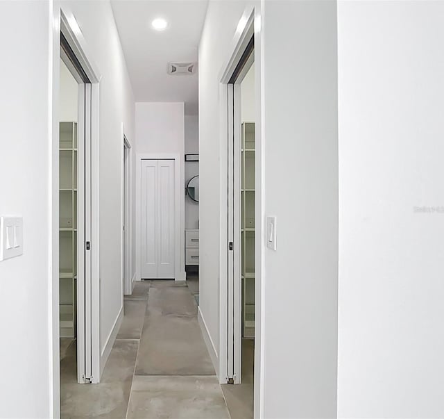 hall featuring recessed lighting, baseboards, visible vents, and concrete flooring