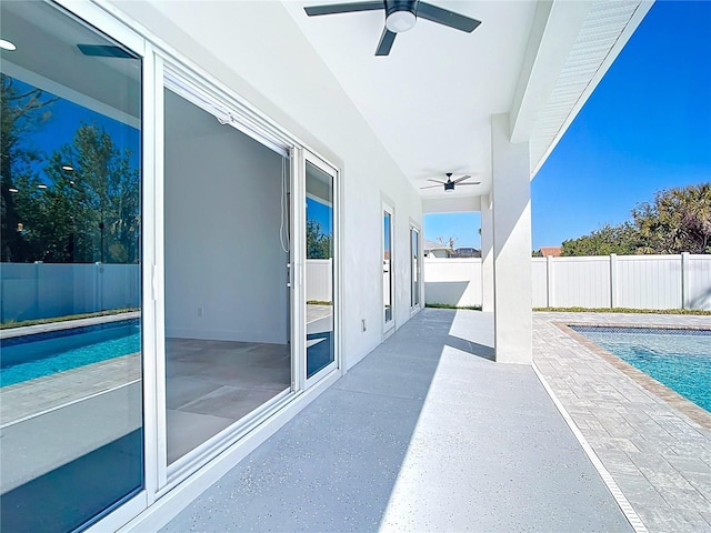 view of patio / terrace with a fenced backyard, a fenced in pool, and ceiling fan