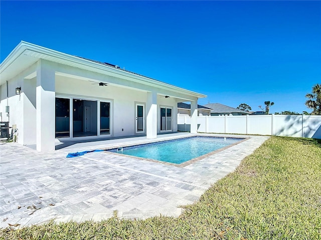 view of pool featuring a ceiling fan, a patio, a fenced backyard, a yard, and a fenced in pool