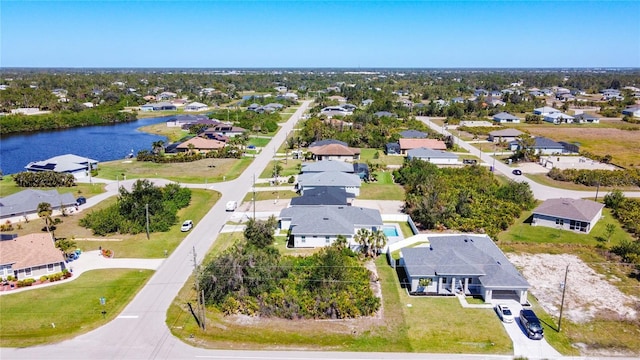 drone / aerial view with a residential view and a water view