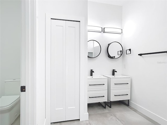 159 Antilla Dr, Rotonda West, FL 33947 - bathroom featuring vanity, baseboards, concrete flooring, and toilet