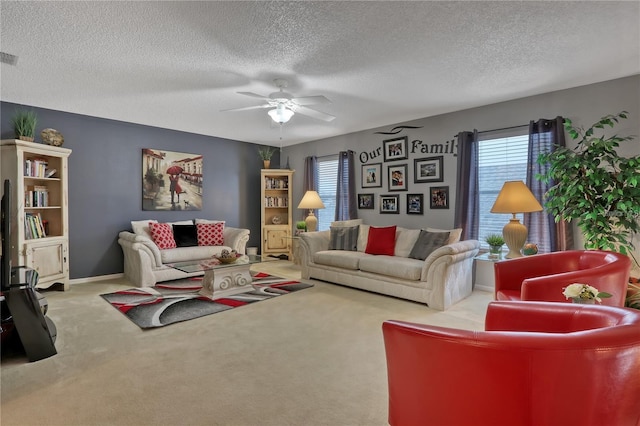 carpeted living area with ceiling fan, a textured ceiling, and a wealth of natural light