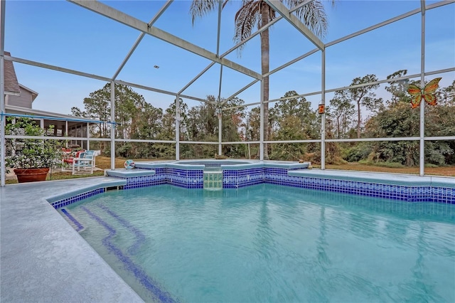 view of pool featuring glass enclosure, a pool with connected hot tub, and a patio