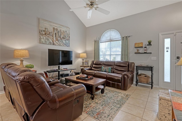 living area with high vaulted ceiling, ceiling fan, baseboards, and light tile patterned floors