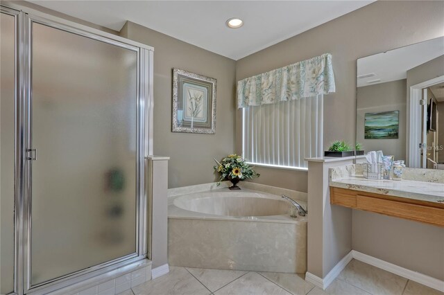 bathroom featuring vanity, a stall shower, tile patterned flooring, and a bath