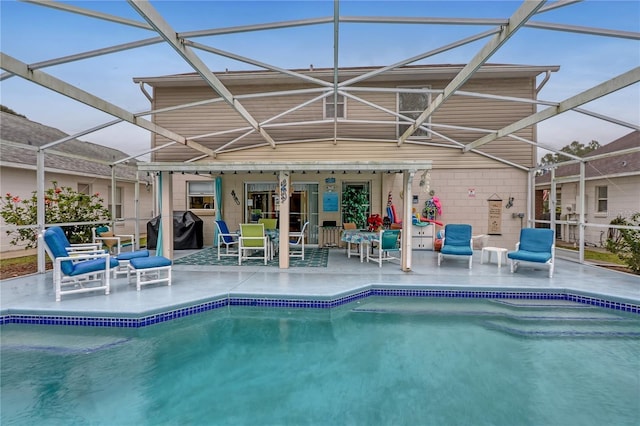 pool with a lanai, a grill, and a patio