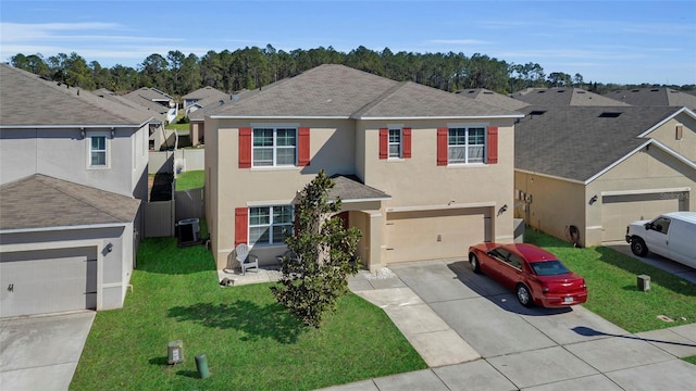 traditional home with stucco siding, a residential view, concrete driveway, and a front lawn