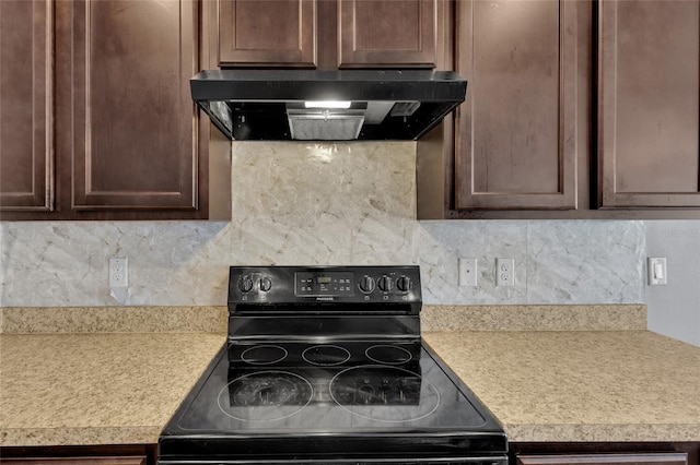 kitchen with decorative backsplash, light countertops, electric range, and exhaust hood