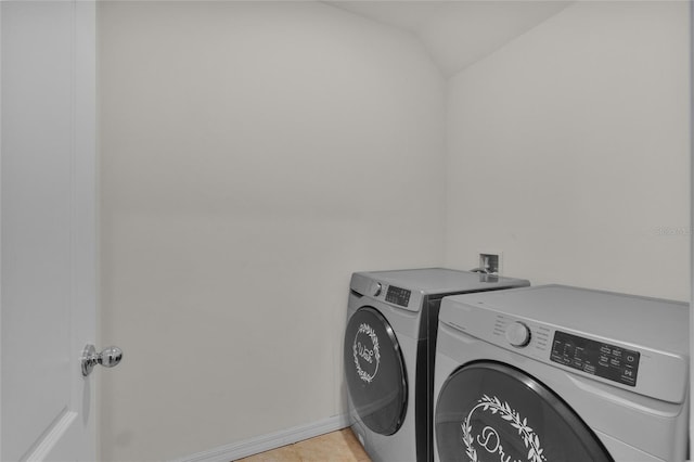 laundry room with baseboards, laundry area, and washing machine and clothes dryer