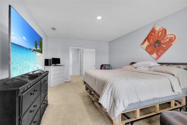 bedroom featuring visible vents and light colored carpet