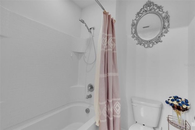 bathroom with toilet and shower / bath combo with shower curtain