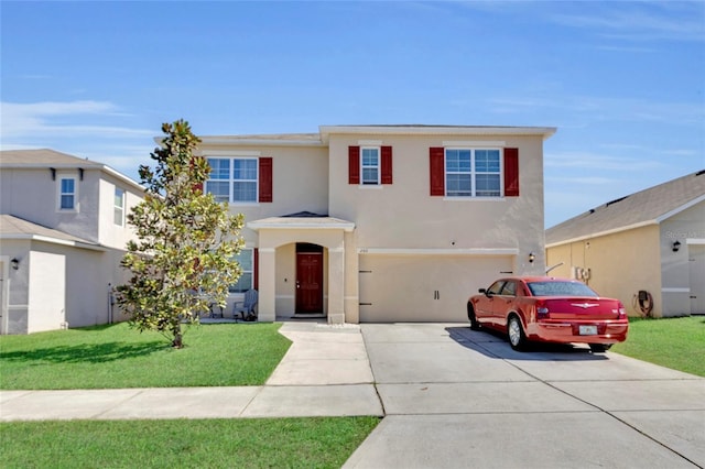 traditional home featuring stucco siding, an attached garage, concrete driveway, and a front yard