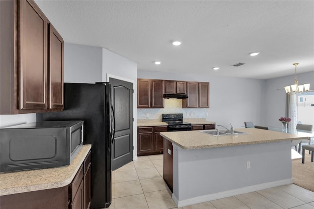 260 Willow Bend Dr, Davenport, FL 33897 - kitchen featuring black electric range oven, under cabinet range hood, light countertops, decorative backsplash, and an island with sink