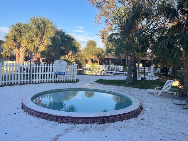 view of pool featuring fence