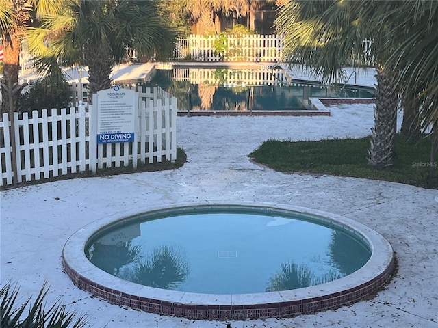 view of swimming pool with fence