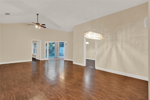 unfurnished living room featuring baseboards, visible vents, dark wood-style flooring, high vaulted ceiling, and ceiling fan with notable chandelier