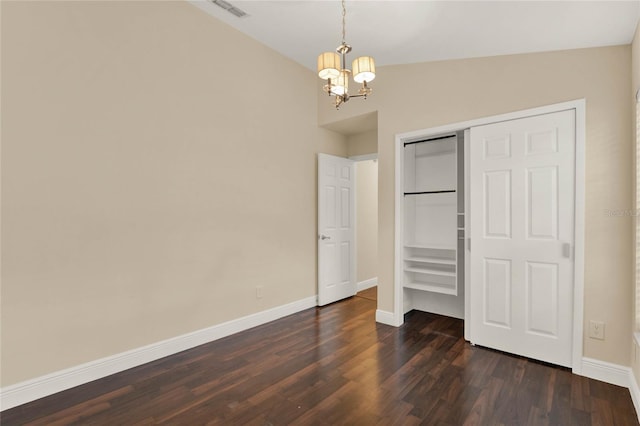 unfurnished bedroom with lofted ceiling, baseboards, visible vents, and dark wood-type flooring