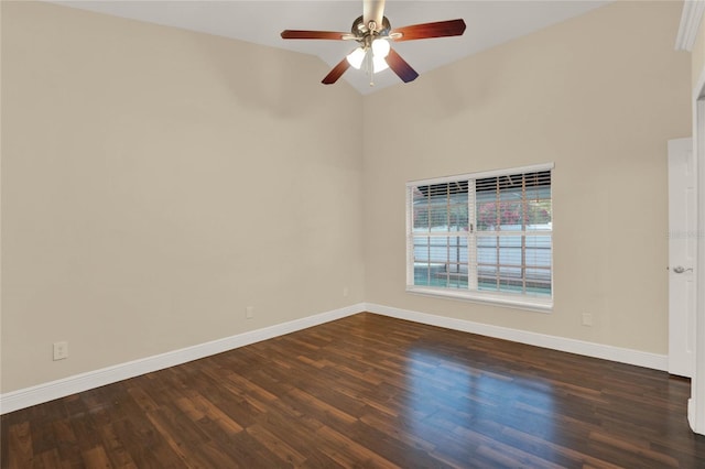 unfurnished room featuring dark wood finished floors, a ceiling fan, and baseboards