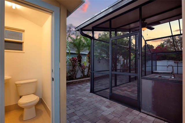 view of patio / terrace featuring a sunroom and a sink