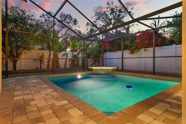 view of pool featuring a patio, a fenced backyard, glass enclosure, and a fenced in pool