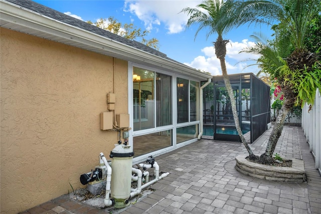 view of patio / terrace with a lanai and fence