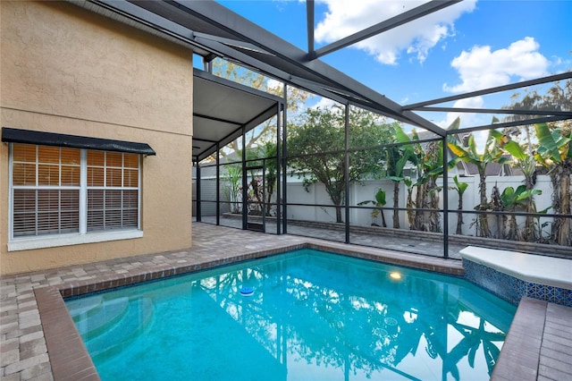 view of pool with a fenced in pool, glass enclosure, a patio, and fence