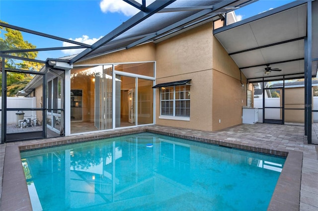 view of swimming pool with a fenced in pool, a lanai, a patio area, and ceiling fan