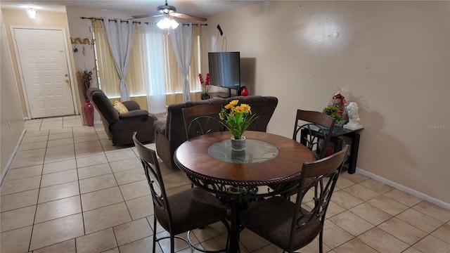 dining room featuring light tile patterned floors, ceiling fan, and baseboards