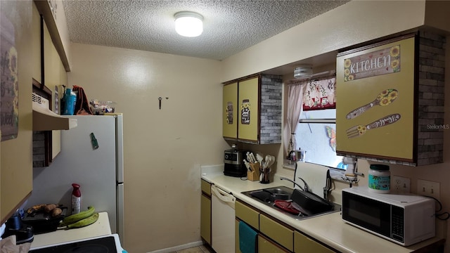 kitchen with a sink, a textured ceiling, light countertops, and dishwasher