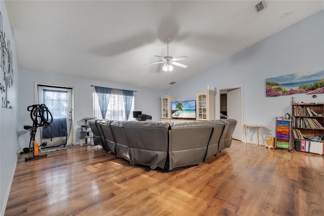 living area with lofted ceiling, ceiling fan, light wood-type flooring, and visible vents