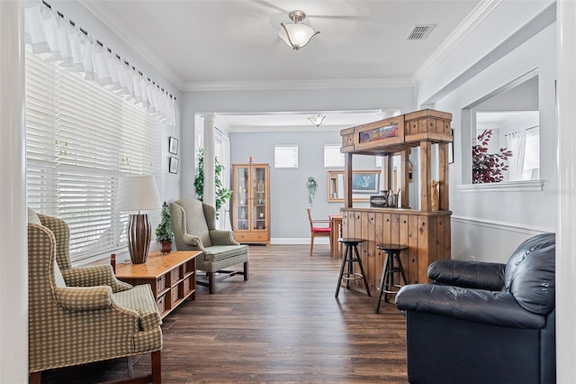 3304 Cat Brier Trl, Harmony, FL 34773 - living area featuring dark wood-type flooring, visible vents, baseboards, ornate columns, and crown molding