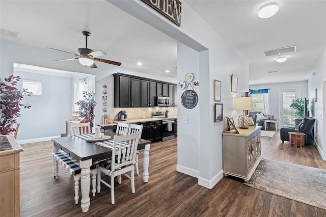 3304 Cat Brier Trl, Harmony, FL 34773 - dining room with dark wood-type flooring, a ceiling fan, visible vents, and baseboards