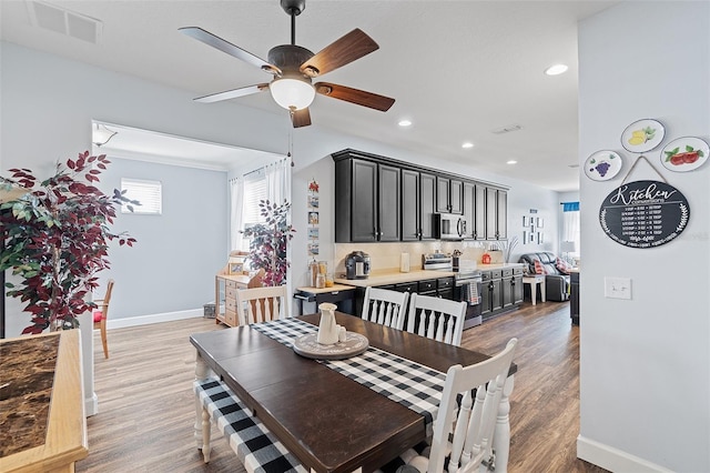 3304 Cat Brier Trl, Harmony, FL 34773 - dining room with light wood-style floors, baseboards, visible vents, and recessed lighting