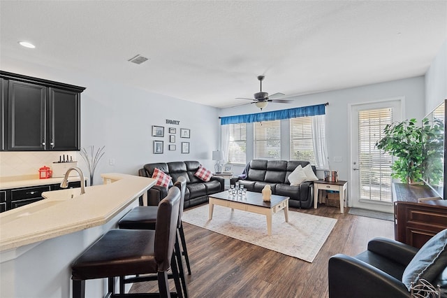 3304 Cat Brier Trl, Harmony, FL 34773 - living area featuring dark wood-style floors, plenty of natural light, visible vents, and a ceiling fan