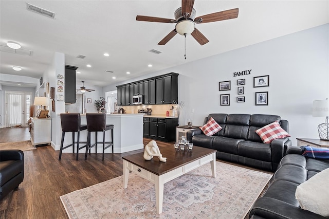 3304 Cat Brier Trl, Harmony, FL 34773 - living room with dark wood-style floors, visible vents, a ceiling fan, and recessed lighting